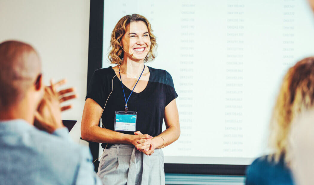 a woman presenting to a room of people